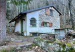 Detached house with garden and woods.