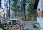 Detached house with garden and woods.