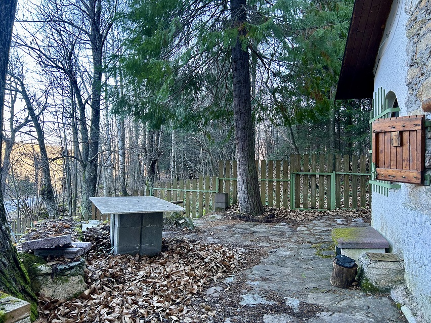 Detached house with garden and woods.