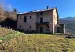 Farmhouse with land and private water source.