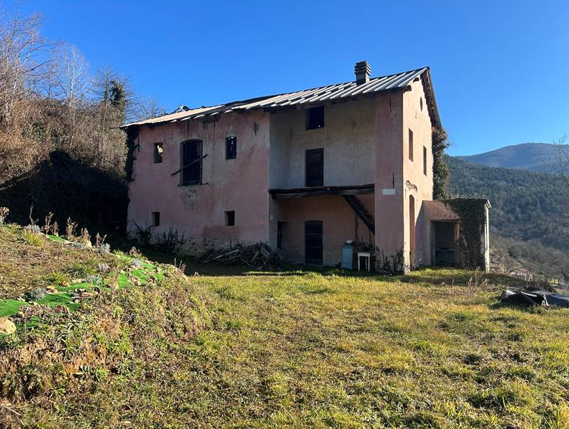 Farmhouse with land and private water source.