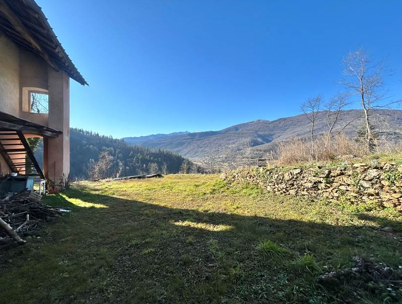 Farmhouse with land and private water source.