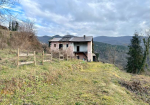 Farmhouse with land and private water source.