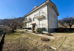 Large semi-detached villa with surrounding land.