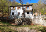 Detached villa with surrounding land.