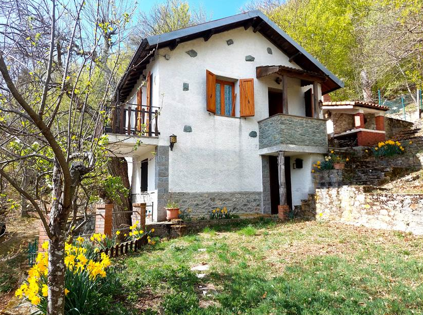 Detached villa with surrounding land.