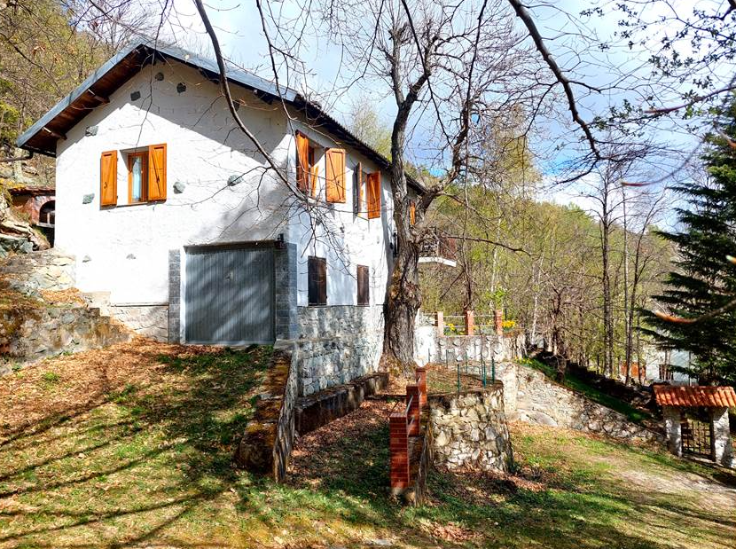 Detached villa with surrounding land.